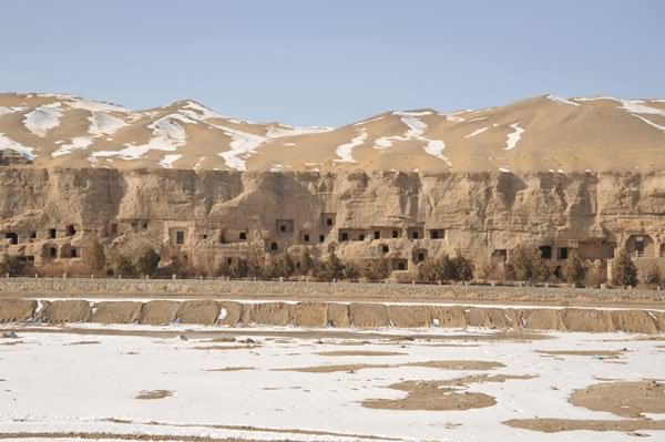 The Mogao Caves Are Carved Into Face Of A Sandstone Cliff At Dunhuang