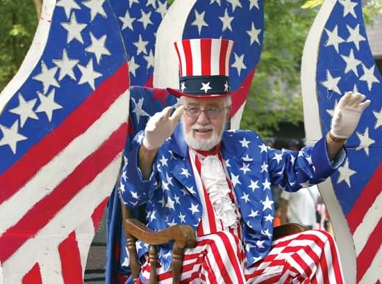 A Man Patriotically Dressed As Uncle Sam Participates In Independence Day Parade