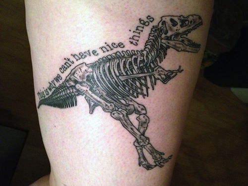 Amazing Dinosaur Skeleton Tattoo On Bicep