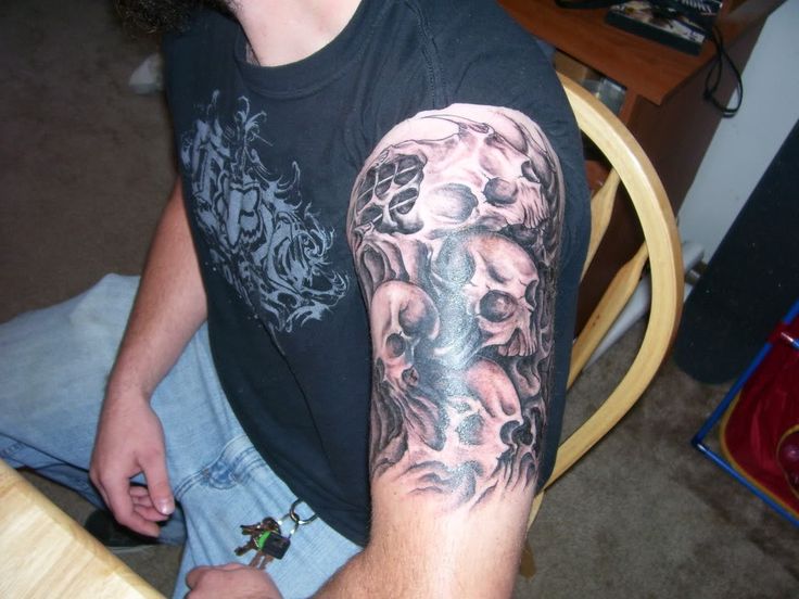 Amazing Skulls Tattoo On Left Half Sleeve