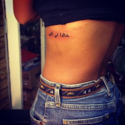Arabic Lettering Tattoo On Girl Left Side Rib