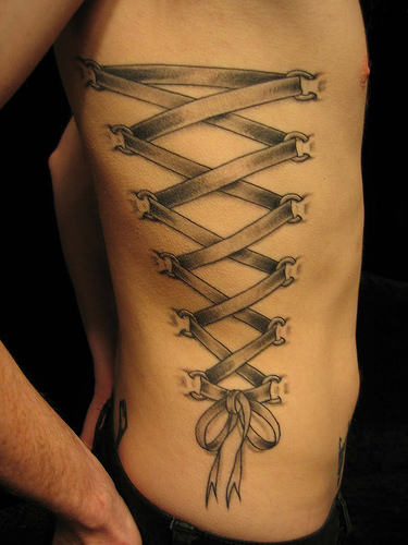 Black And Grey Corset Bow Tattoo On Right Side Rib