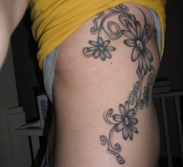 Black And Grey Daisy Flowers Tattoo On Side Rib