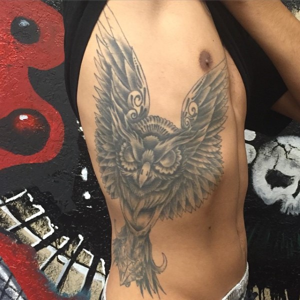 Black And Grey Owl Tattoo On Man Right Side Rib