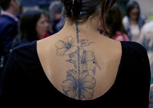 Black And White Hibiscus Flowers Tattoo On Girl Upper Back