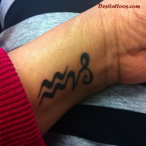 Black Aquarius Tattoo On Left Wrist