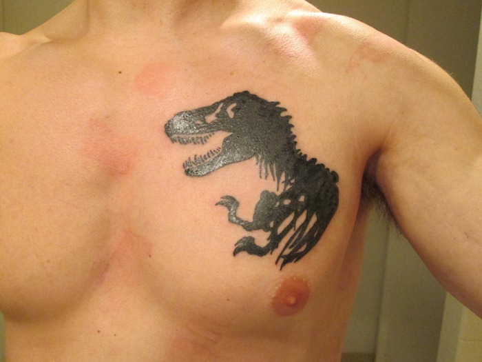 Black Dinosaur Tattoo On Chest