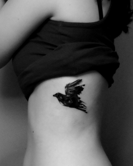 Black Flying Bird Tattoo On Girl Side Rib