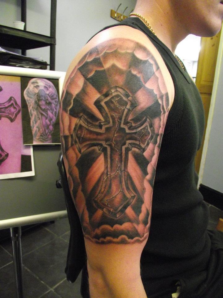 Black Ink Cross Tattoo On Man Right Half Sleeve
