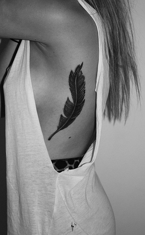 Black Ink Feather Tattoo On Girl Left Upper Side Rib