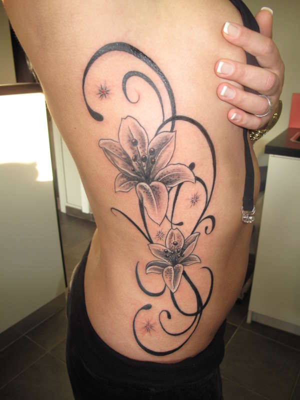 Black Ink Flowers Tattoo On Side Rib