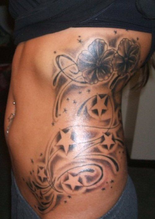 Black Ink Flowers With Stars Tattoo On Girl Left Side Rib