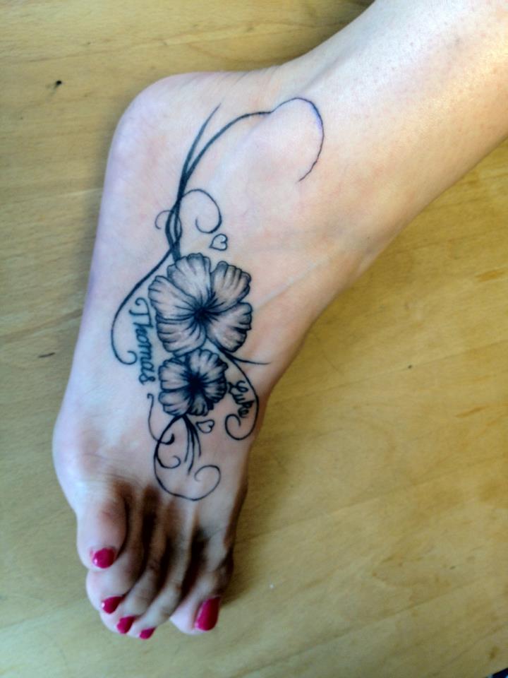Black Ink Hibiscus Flowers Tattoo On Girl Foot
