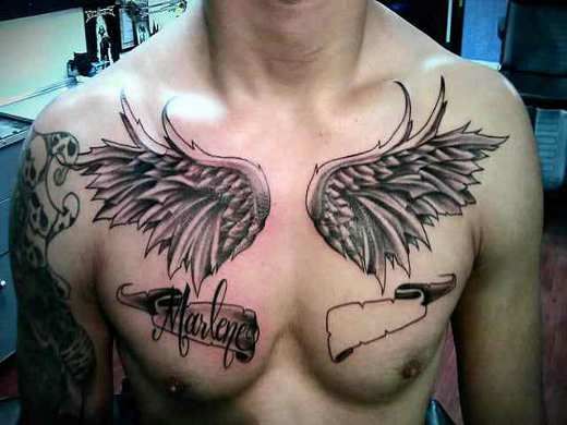 Black Ink Wings With Banner Tattoo On Man Chest