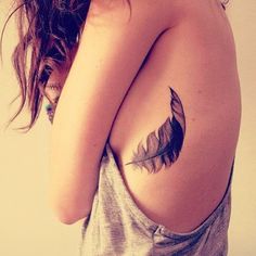 Black Small Feather Tattoo On Girl Side Rib