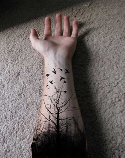 Black Tree Without Leaves With Flying Birds Tattoo On Forearm