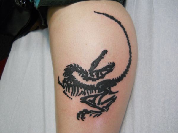 Black Tribal Dinosaur Skeleton Tattoo On Leg