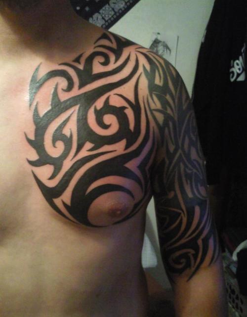Black Tribal Tattoo On Man Left Half Sleeve And Chest