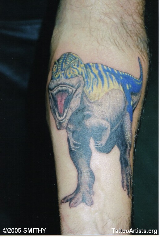 Blue Ink Dinosaur Tattoo Arm