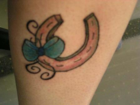 Bow And Horse Shoe Tattoo