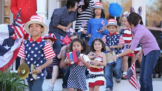 Children Walking In Parade During USA Independence Day Celebration