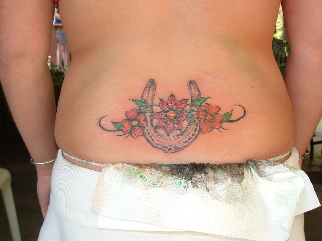 Color Flowers And Horseshoe Tattoo On Lower Back