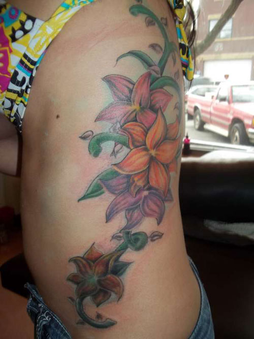 Colorful Flowers Tattoo On Girl Side Rib