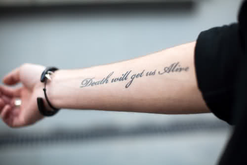 Death Will Get Us Alive Word Tattoo On Right Forearm