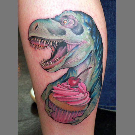 Dinosaur With Cupcake Tattoo On Leg