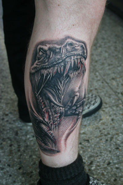 Evil Dinosaur Tattoo On Leg