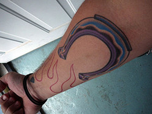 Flaming Horseshoe Tattoo On Right Forearm