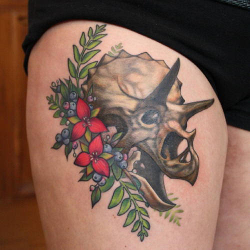 Flowers And Dinosaur Skull Tattoo On Thigh