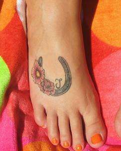 Flowers And Horse Shoe Tattoo On Right Foot