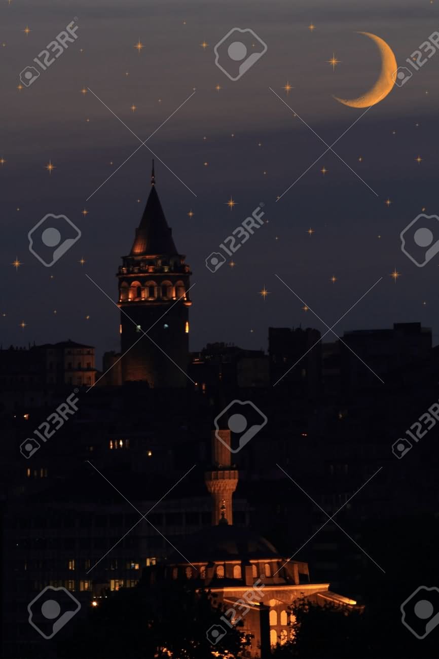 Galata Tower In Istanbul Against Night Sky With Stars And Moon