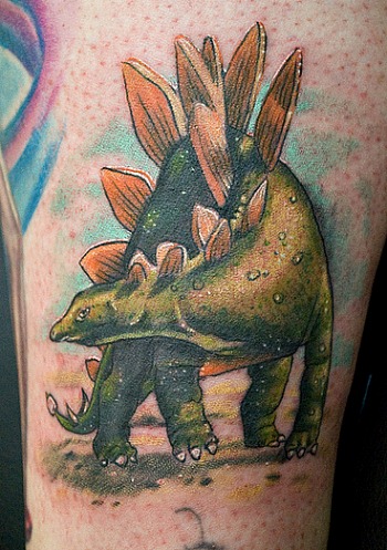 Green Dinosaur Tattoo On Left Bicep
