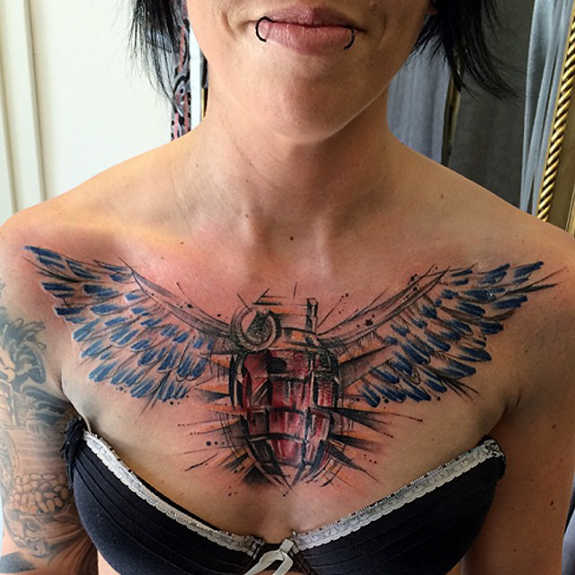 Grenade With Wings Tattoo On Girl Chest