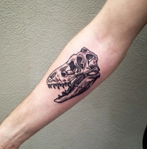 Grey Ink Dinosaur Skull Tattoo On Right Forearm