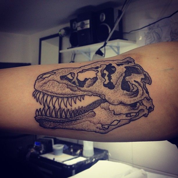 Grey Ink Dinosaur Tattoo On Bicep