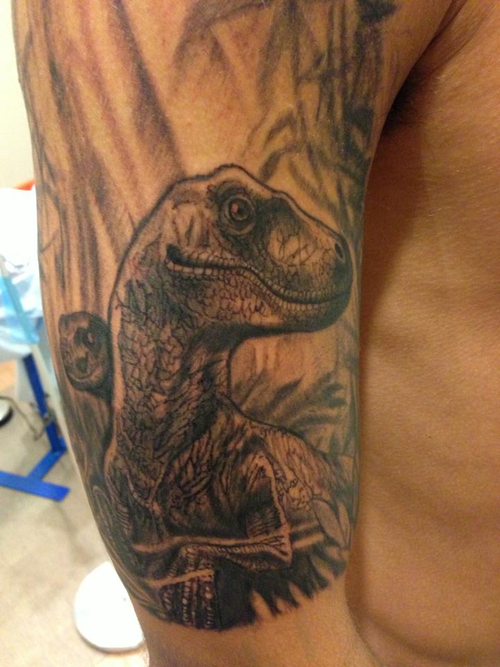 Grey Ink Dinosaur Tattoo On Man Half Sleeve
