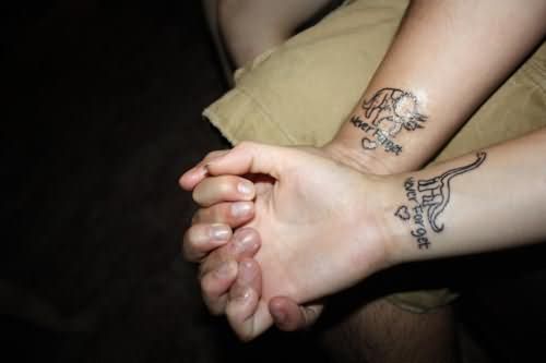 Grey Ink Dinosaur Tattoo On Wrist