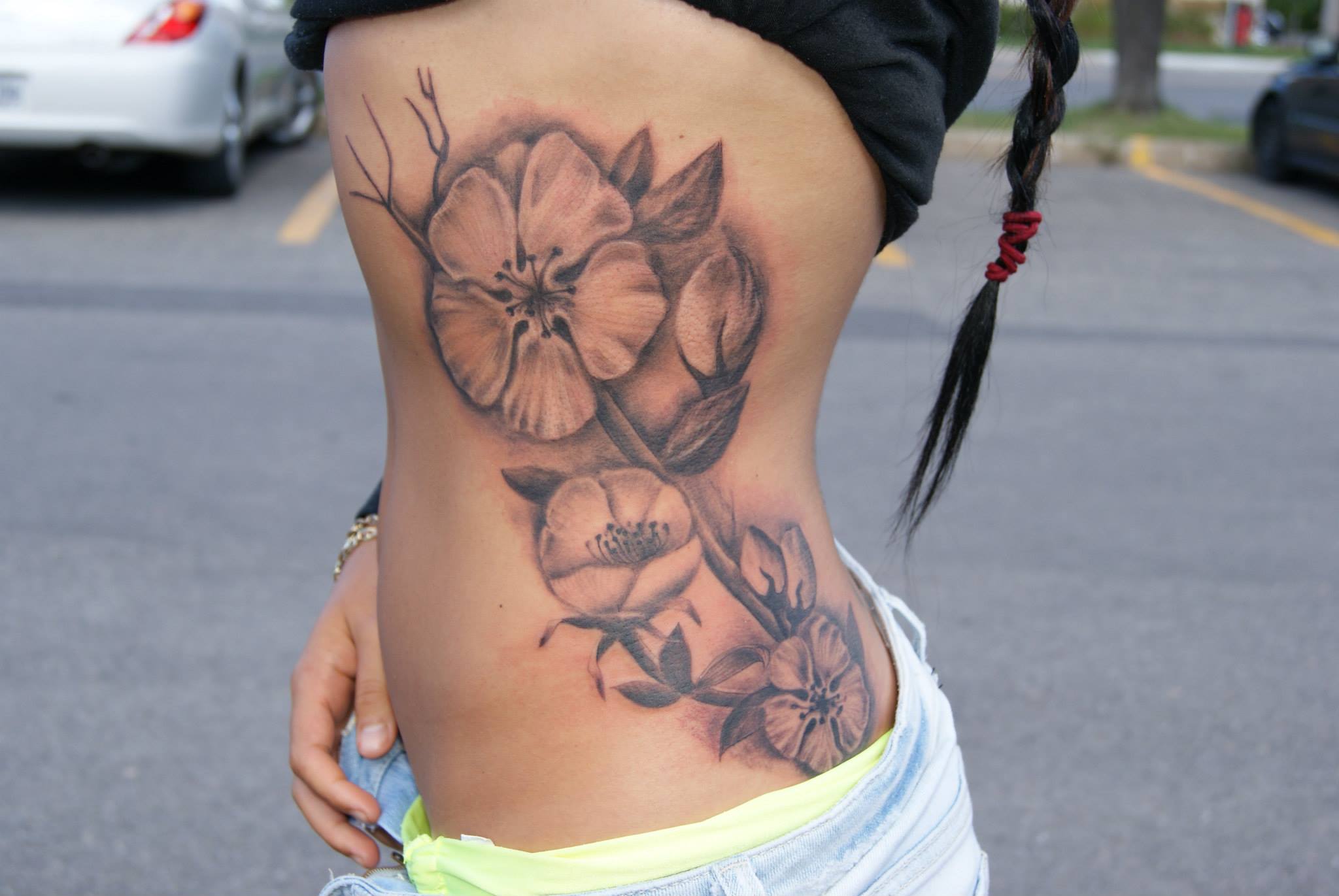Grey Ink Flower Tattoo On Side Rib