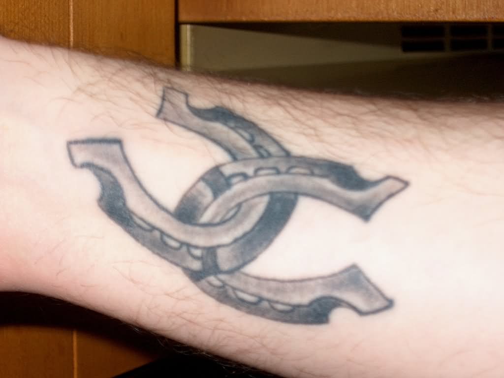 Grey Ink Horse Shoe Tattoos On Forearm