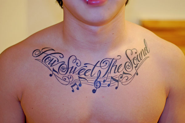 How Sweet The Sound Quote With Music Knots Tattoo On Man Chest