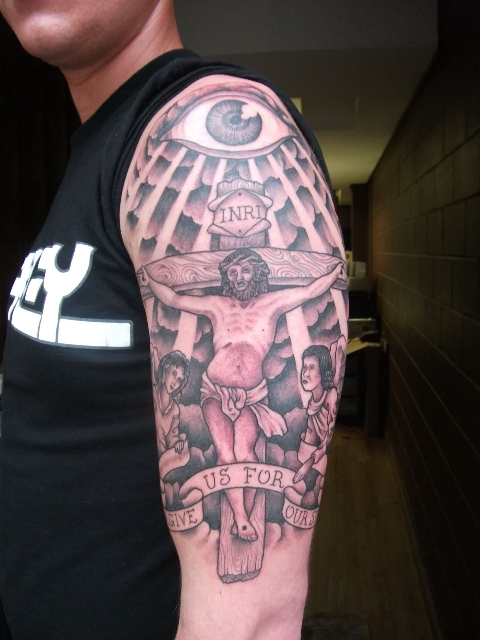 Jesus On Cross With Banner Tattoo On Man Left Half Sleeve