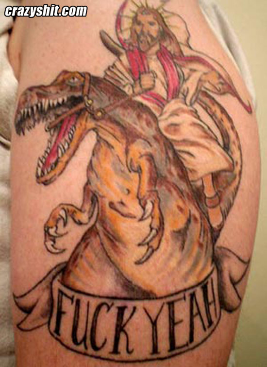 Jesus Riding Dinosaur Tattoo On Left Shoulder