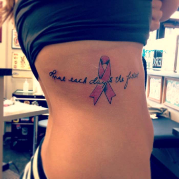 Live Each Day To The Fullest Quote With Cancer Ribbon Tattoo On Side Rib