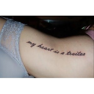 My Heart Is A Traitor Lettering Tattoo On Girl Side Rib