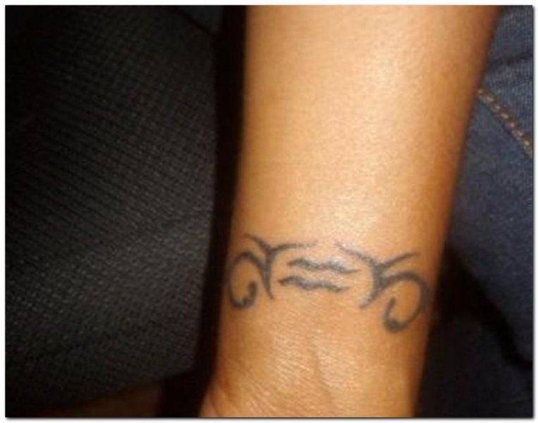 Nice Black Tribal Aquarius Tattoo On Wrist