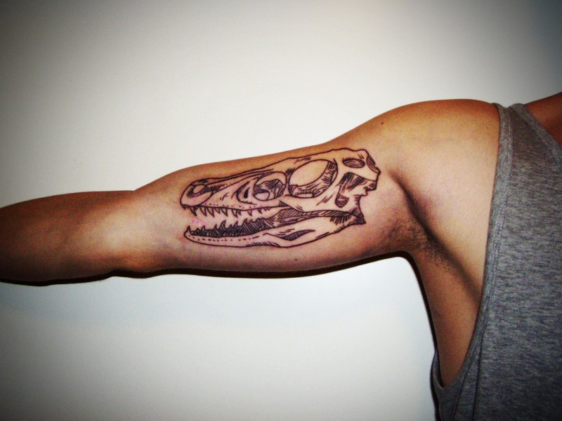 Outline Dinosaur Tattoo On Inner Bicep