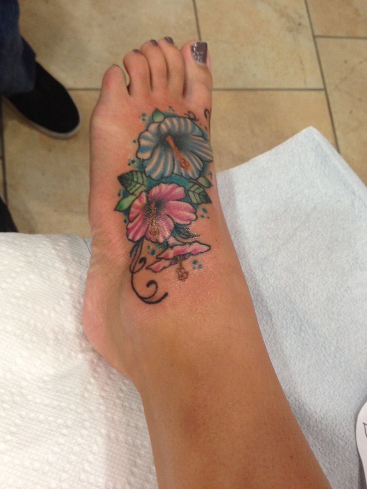 Pink And Blue Hibiscus Flowers Tattoo On Girl Left Foot